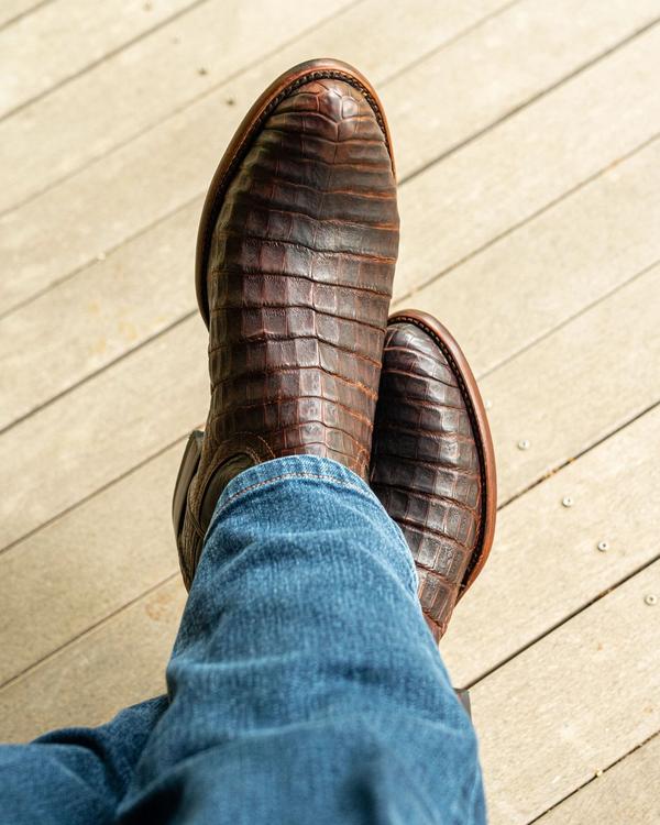 close up picture of Earl Mahogany brown cowboy boots on a man's feet