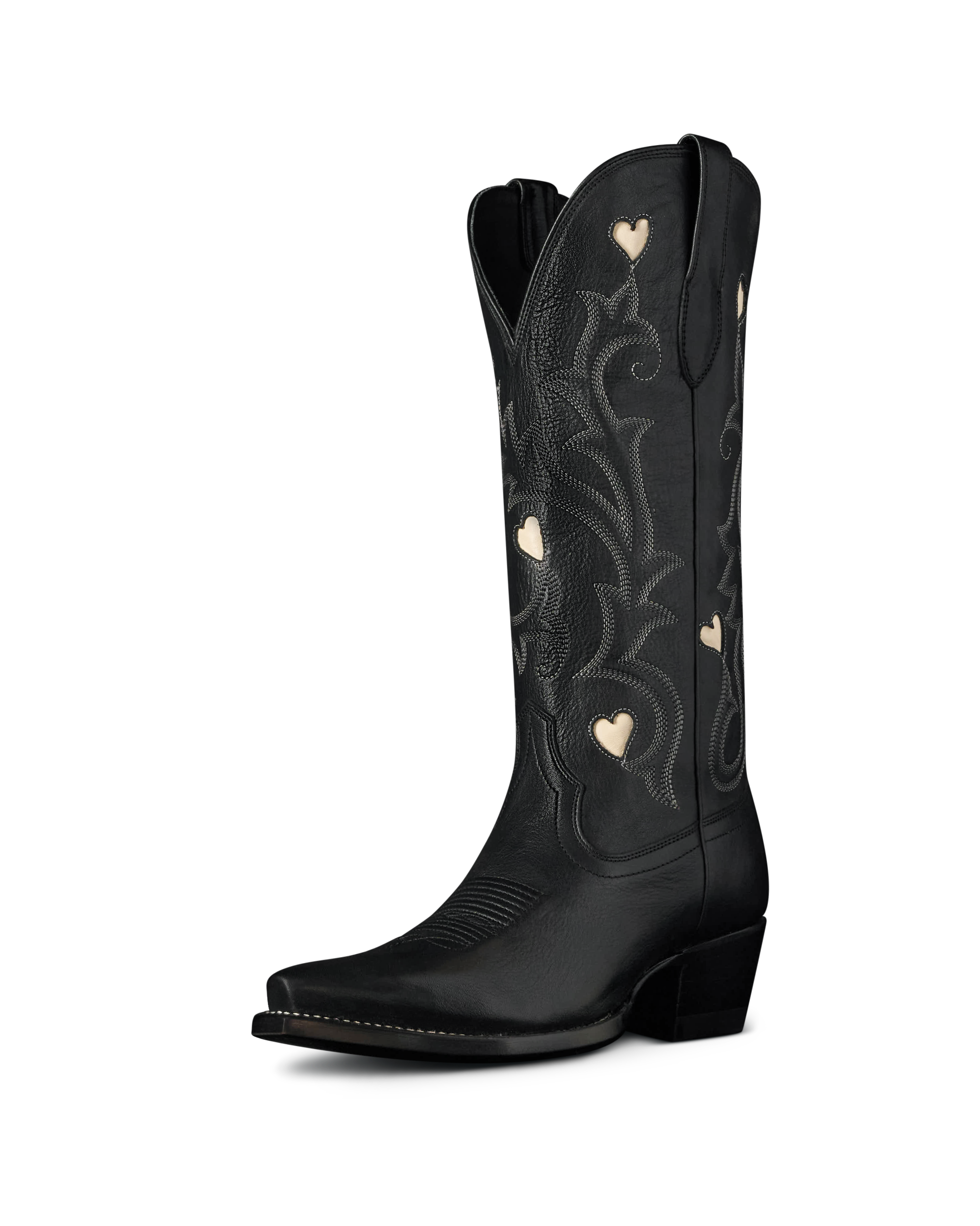 The Annie in Midnight Cowhide. Black leather cowboy boot crafted from premium Midnight Cowhide, featuring embroidered patterns and small heart-shaped cutouts on the shaft, shown against a plain white background.