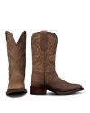 The Tess in Cafe Goat. A pair of brown leather cowboy boots with decorative stitching, inspired by The Tess Goat, one boot standing upright and the other displaying the front view.