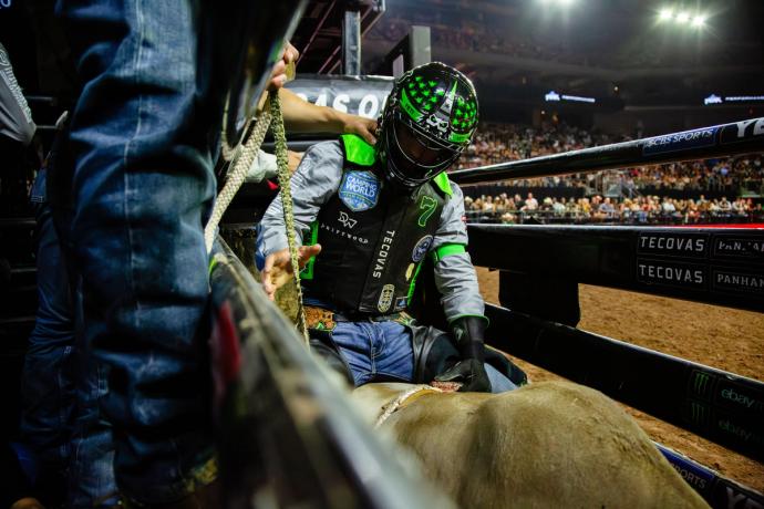 Man getting ready to ride a bull