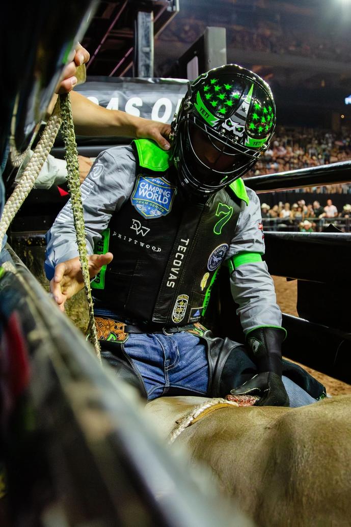 Man getting ready to ride a bull