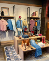 Interior of a boot store with shelves of various styles of western clothing 