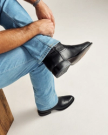 close up picture of Earl midnight black cowboy boots on a man's feet