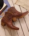 woman in short brown scotch goat zip cowgirl booties