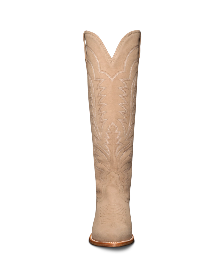 Tan cowboy boot with intricate stitched patterns on a black background.