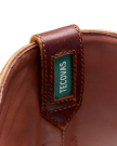 Close-up of a brown leather boot interior showcasing a green label with the text "Teconias" stitched on it.