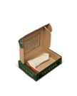 An open Tecovas box displays a single rolled-up white sock with a brown accent, alongside a printed message on the inside lid.