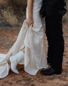 Man and woman standing closely at a wedding