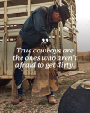 A cowboy in a hat and boots stands by a trailer, adjusting his chaps. Text overlay reads, "True cowboys are the ones who aren’t afraid to get dirty.