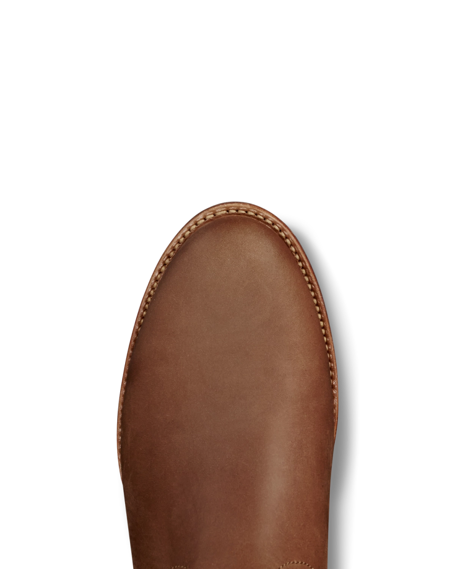The Glen in Khaki Cowhide. A close-up of the toe area of a brown leather shoe crafted from supple cowhide, with visible stitching around the edge.