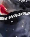 A close-up of a fabric with the word "TECOVAS" printed in bold letters and a pattern of white dots on a dark background.