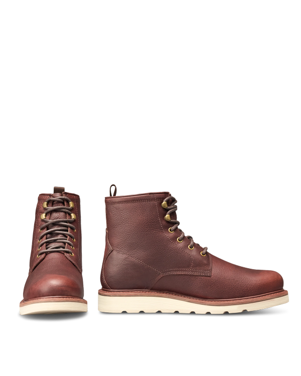 The Knox Lace Up in Cognac Cowhide. A pair of Cognac cowhide lace-up boots with white wedge soles.