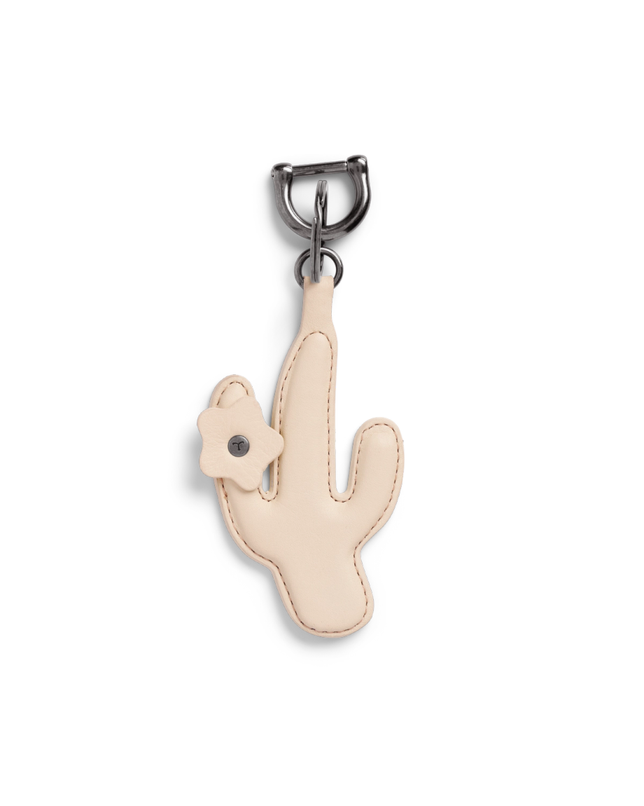 A beige cactus-shaped leather keychain with a small flower detail attached near the top left side.