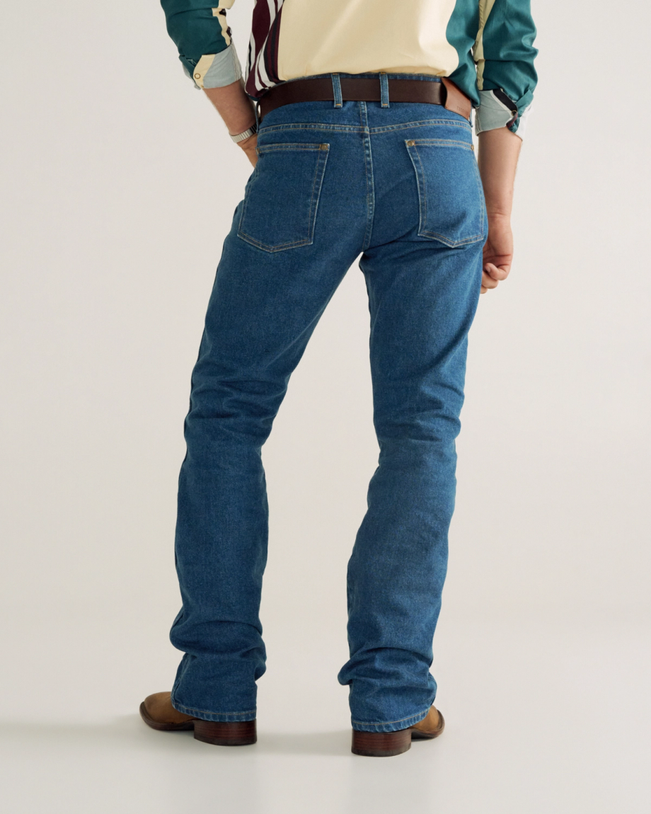Back view of Men's Modern Bootcut Heritage Denim - Medium Blue on model