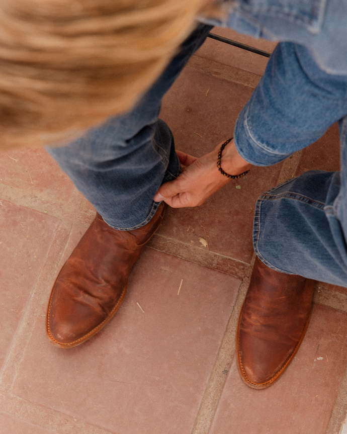 close up picture of Earl scotch brown cowboy boots on a man's feet