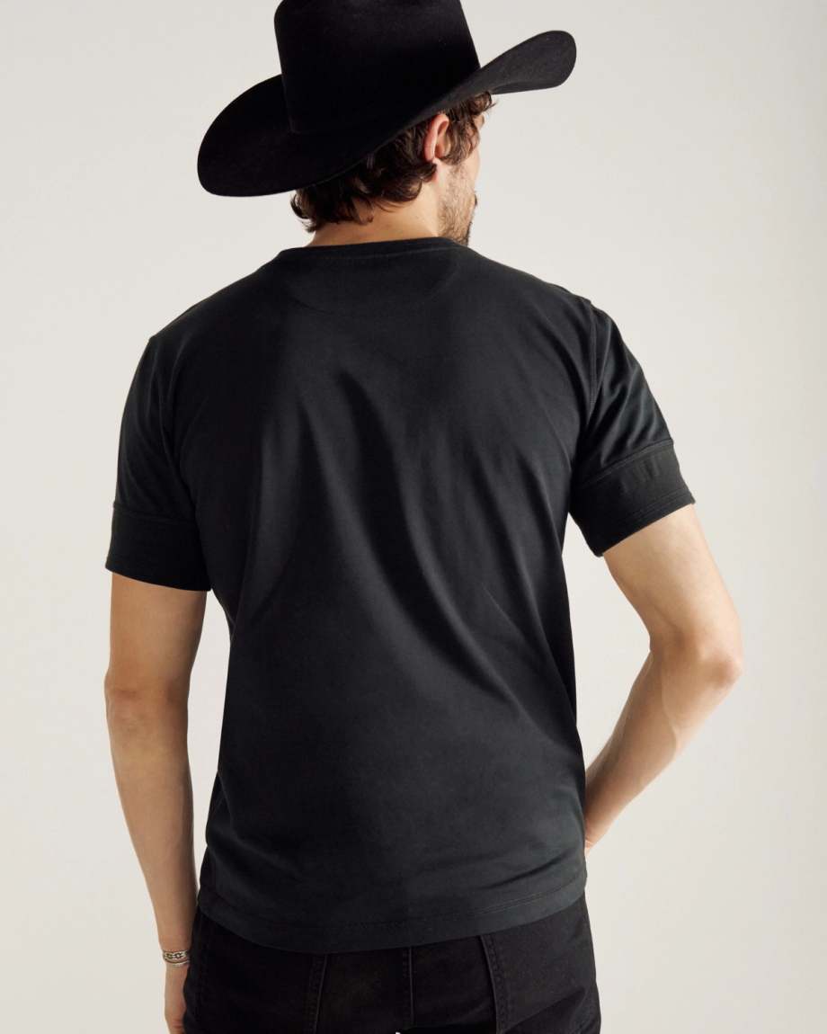 Closeup of man wearing a black henley