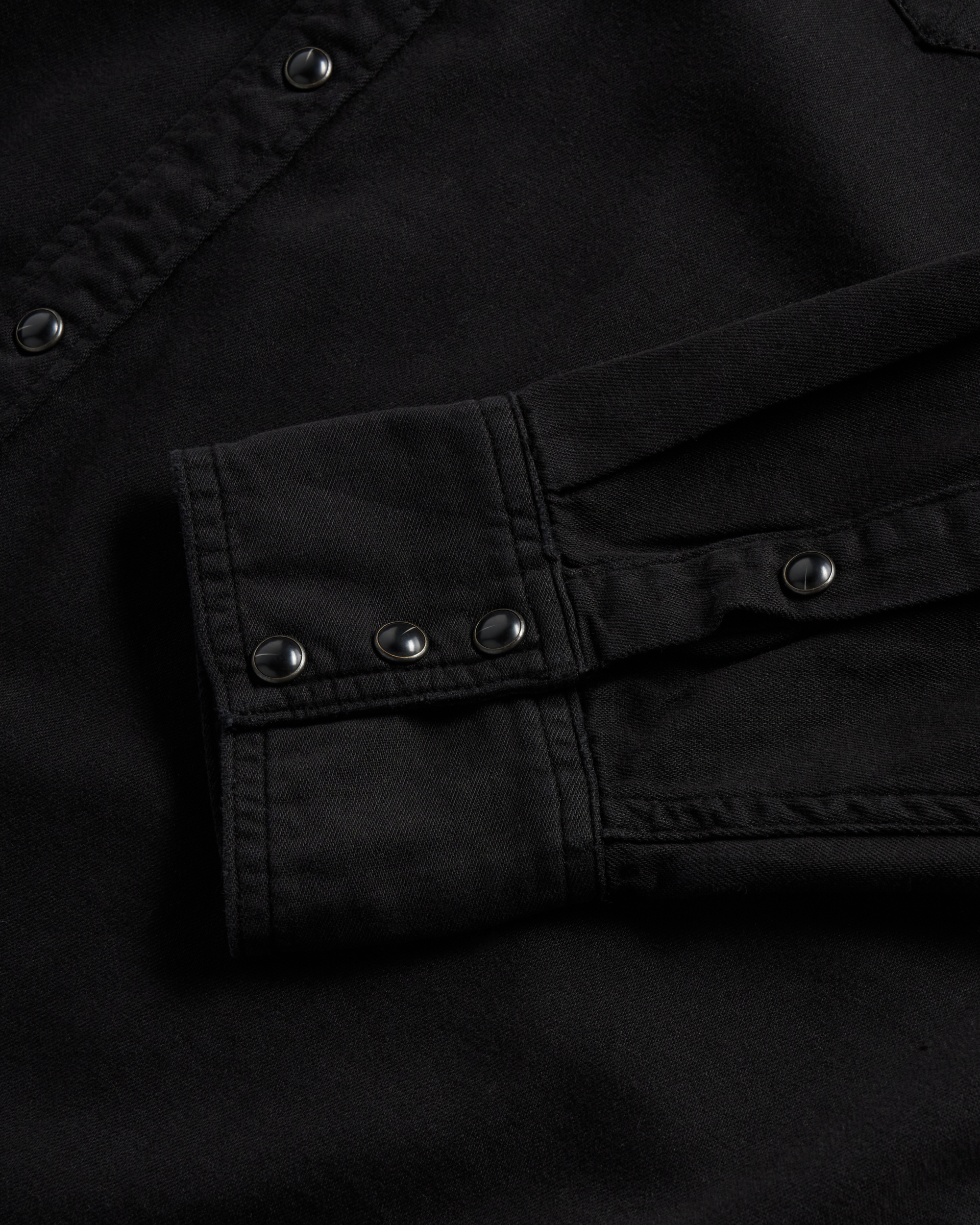 Closeup detail view of Men's Denim Long Sleeve Pearl Snap - Black