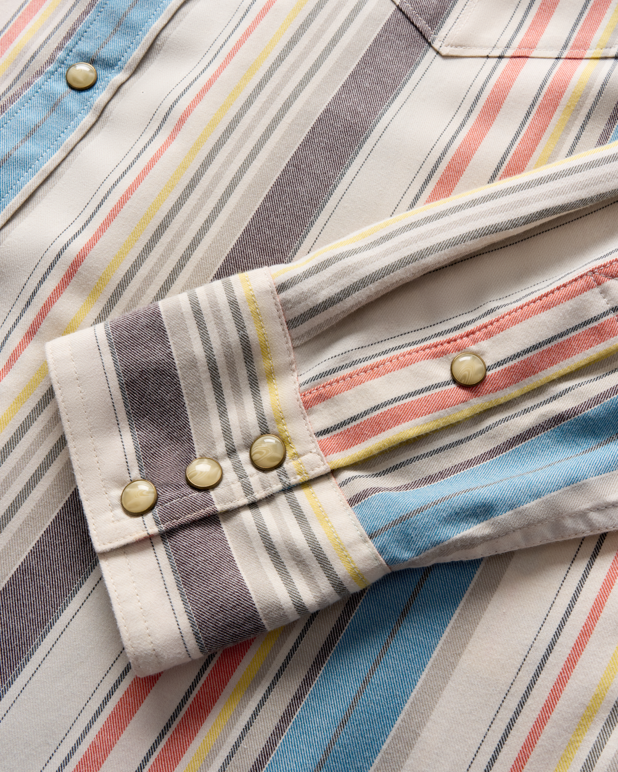 Closeup detail view of Men's Flying-T Foundation Weight Pearl Snap - Tan Multi Wide Stripe