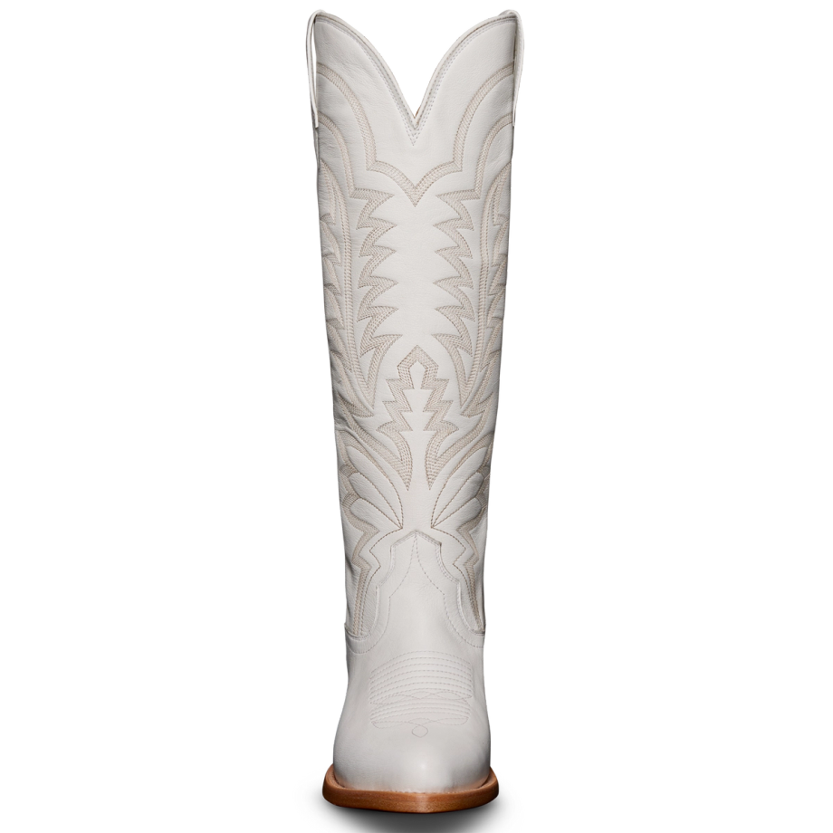A single tall white cowboy boot with intricate stitching and a tan heel, viewed from the front.