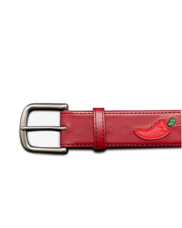 A red leather belt with a silver buckle and an embroidered red chili pepper near the strap loop, displayed against a black background.