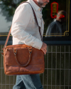 Man wearing the Bartlett Briefcase walking on South Congress