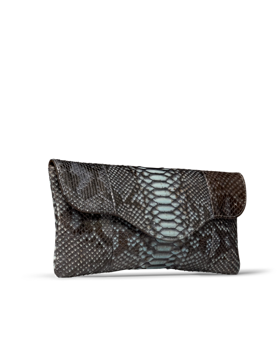 A clutch handbag made of textured material with a blue and dark brown scale pattern and a flap closure.