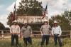 4 men in front of a sign saying ranger cattle