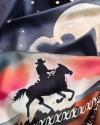 Close-up of fabric featuring a silhouette of a cowboy on a horse against a colorful night sky with a full moon and stars.