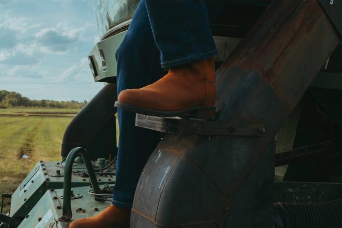 man wearing work boots on equipment