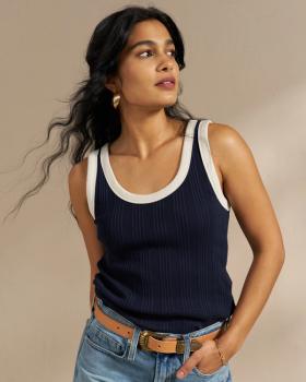 Woman wearing the ribbed tank in navy in a studio