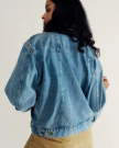 Back view of Women's Denim Trucker Jacket - Medium Wash on model