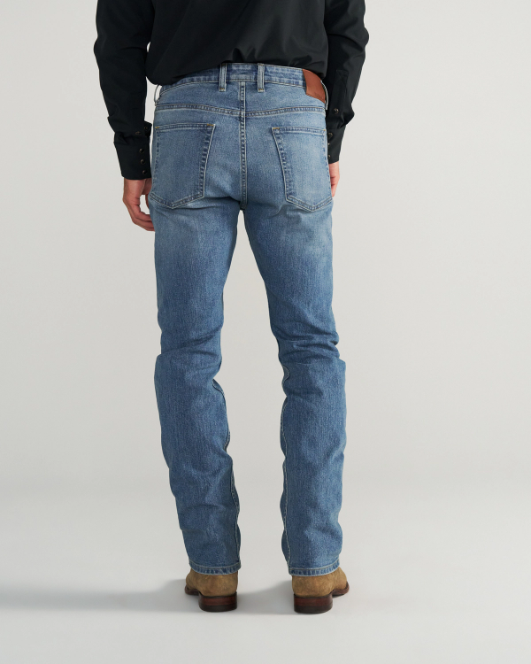 Back view of Men's Slim Straight Stretch Denim - Medium Light on model