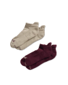 Two pairs of ankle socks, one beige and one dark red, are displayed on a black background.