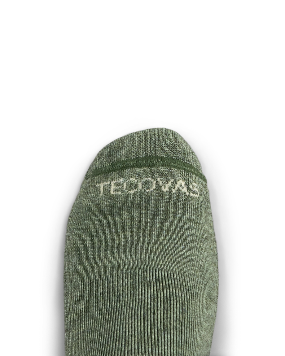 A close-up of a green sock with the word "Tecovas" in white text near the toe, against a plain white background.
