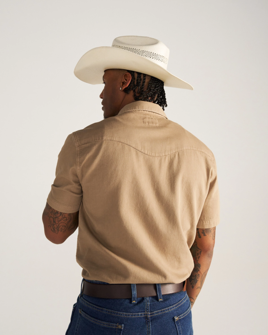 Closeup detail view of Men's Denim Pearl Snap SS - Coriander / Multi