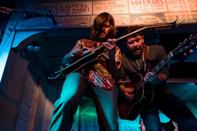 men playing guitar on stage