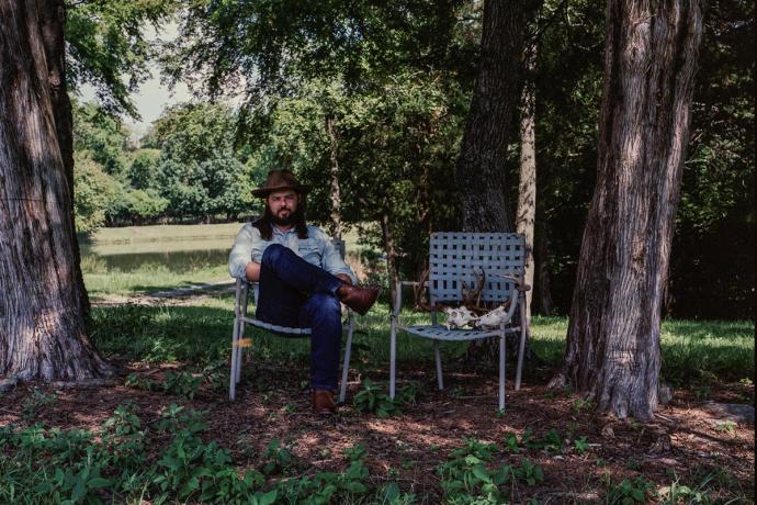 man in a chair in a yard