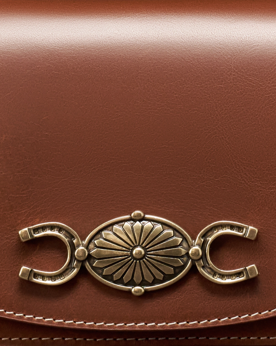 Closeup detail view of Concho Chain Crossbody - Saddle