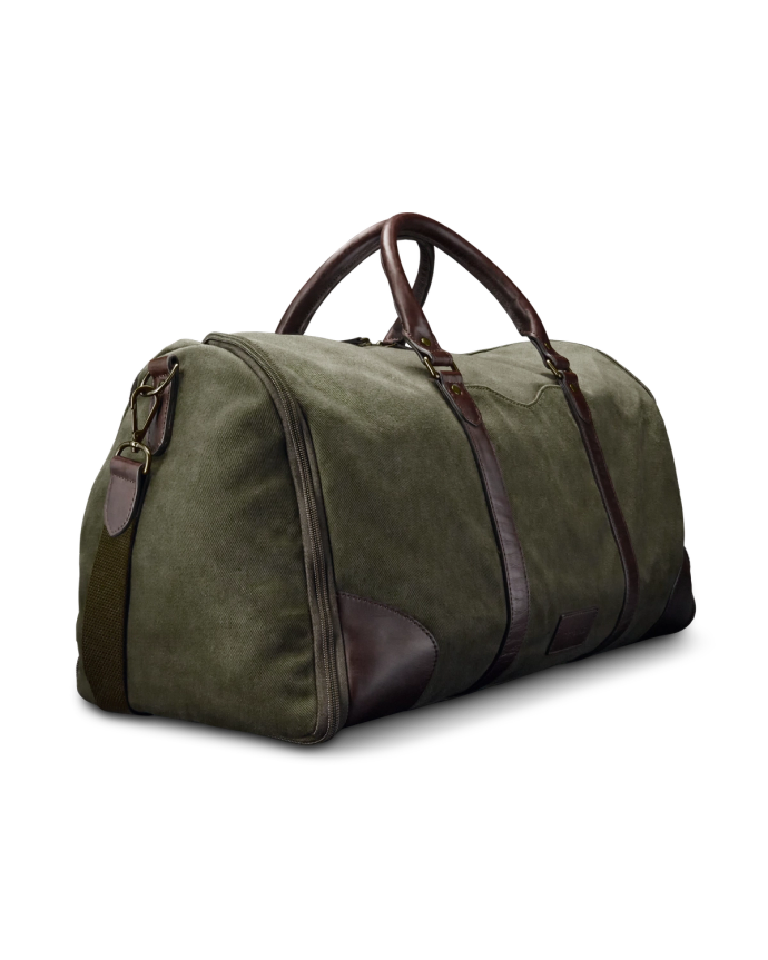 A green canvas and brown leather duffel bag with two handles and a detachable strap sits against a black background.