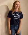 Woman wearing the Navy Tecovas Western Goods t shirt. 