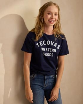 Woman wearing the Navy Tecovas Western Goods t shirt. 