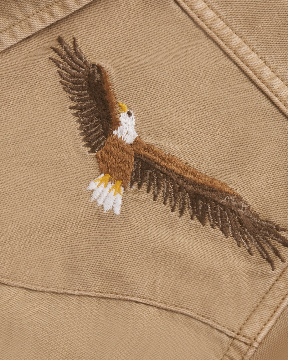 Closeup detail view of Men's Denim Pearl Snap SS - Coriander / Multi