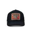 A black mesh trucker hat with a rectangular patch reading "Born in Texas Tecovas Built to Last" in tan, white, and orange colors.