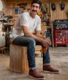 Man sitting on wooden box in roper boots