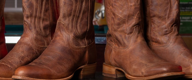 Brown Cowboy Boots in a semi-circle on a table