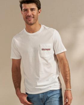 Man wearing a white graphic tee in a photo studio