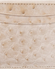 Close-up of a beige textured leather surface with visible stitching and raised bumps, suggesting it is ostrich leather.