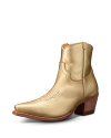 A shiny gold cowboy boot with a pointed toe and brown wooden heel, featuring decorative stitching on the upper.