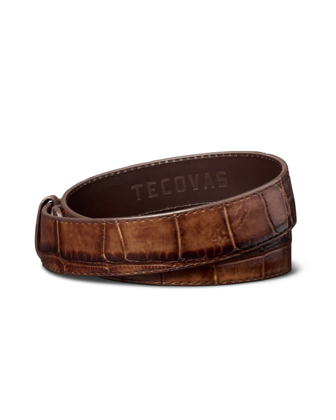 Brown leather belt with a crocodile pattern and the word "Tecovas" embossed on the inner side.