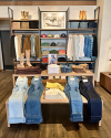 Interior of a boot store with shelves of various styles of western clothing 